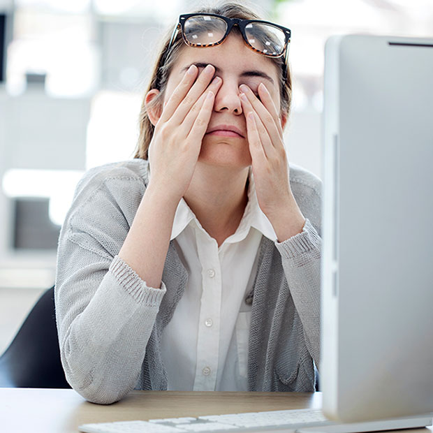 Tired woman touching her eyes